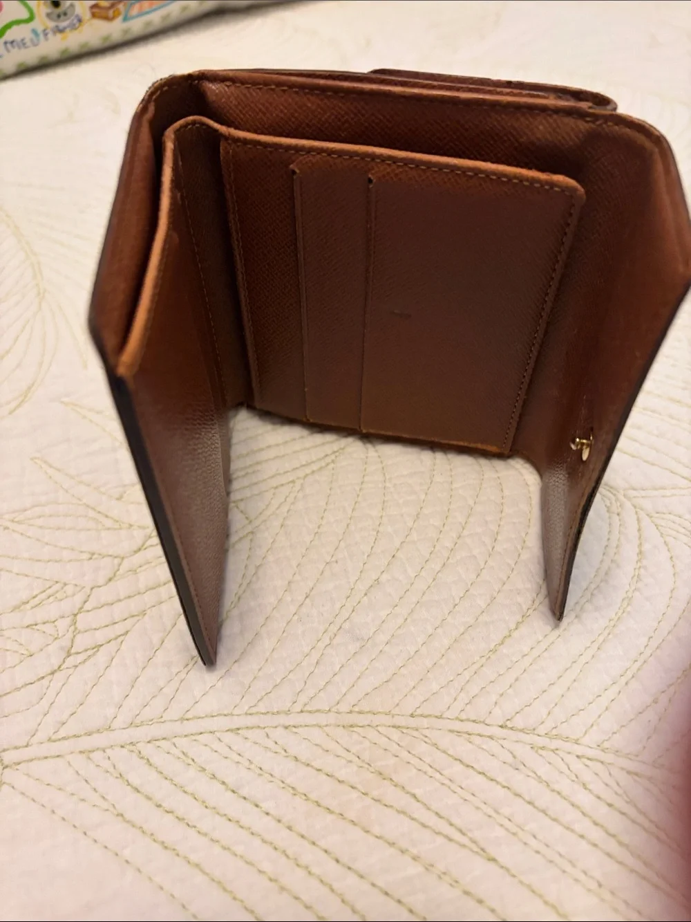 Louis Vuitton trifold snap wallet. Authentication provided.